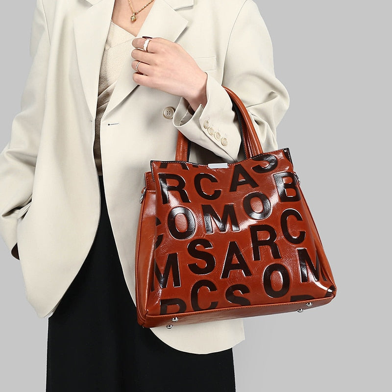 Kayla Letter Embossed Trapeze Bag - 4 Colors