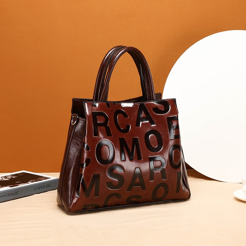 Kayla Letter Embossed Trapeze Bag - 4 Colors